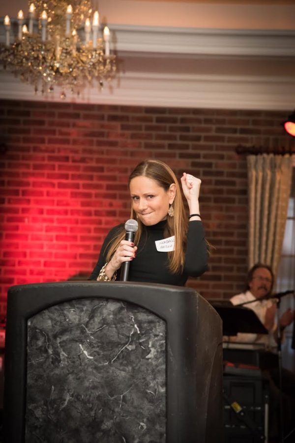 Colon Cancer Survivor Kendall Bello of Bucks County gestures triumph and thankfulness after her speech.
